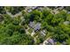 An aerial view of the property in a leafy neighborhood reveals mature trees and manicured greenery at 2805 Van Dyke Ave, Raleigh, NC 27607