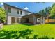Large backyard with lush green lawn and a covered patio area for outdoor relaxation and entertainment at 2805 Van Dyke Ave, Raleigh, NC 27607