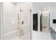 Luxurious bathroom with glass-enclosed marble shower, brass fixtures, and view into Primary bedroom at 2805 Van Dyke Ave, Raleigh, NC 27607