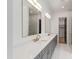 Elegant bathroom featuring double sinks, a quartz countertop, and gold fixtures with a view to the glass shower at 2805 Van Dyke Ave, Raleigh, NC 27607