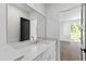 Bathroom with a modern vanity, large mirror, and view to bedroom at 2805 Van Dyke Ave, Raleigh, NC 27607