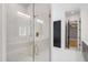 Elegant glass-enclosed shower with marble tile, bench, and gold hardware in a well-lit bathroom at 2805 Van Dyke Ave, Raleigh, NC 27607