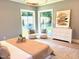 Bright bedroom featuring large windows, cozy seating, a dresser, and a comfortable bed at 2805 Van Dyke Ave, Raleigh, NC 27607