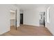 Sunlit bedroom featuring hardwood floors, a walk-in closet, and a view of an ensuite bathroom at 2805 Van Dyke Ave, Raleigh, NC 27607