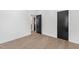 Spacious bedroom with light hardwood floors and neutral walls and trim at 2805 Van Dyke Ave, Raleigh, NC 27607
