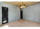 Spacious bedroom features wood floors, black doors and a vaulted wood ceiling with modern chandelier at 2805 Van Dyke Ave, Raleigh, NC 27607