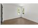 Bedroom featuring beautiful hardwood floors, two windows, and white trim at 2805 Van Dyke Ave, Raleigh, NC 27607
