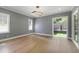 Bedroom featuring gray walls, hardwood flooring, window shutters, and natural lighting at 2805 Van Dyke Ave, Raleigh, NC 27607