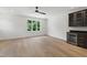 Bonus room with wood floors, wet bar, beverage fridge, window, and neutral walls at 2805 Van Dyke Ave, Raleigh, NC 27607