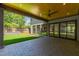 Covered patio with brick flooring, a ceiling fan, and views of the manicured backyard and modern home design at 2805 Van Dyke Ave, Raleigh, NC 27607