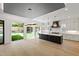 Open kitchen with dark island, marble countertops, and view to backyard at 2805 Van Dyke Ave, Raleigh, NC 27607