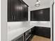 Secondary kitchen area featuring dark cabinetry, white countertops, and stainless appliances at 2805 Van Dyke Ave, Raleigh, NC 27607
