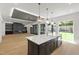 The open-concept kitchen features a center island with pendant lighting, custom cabinetry, and stainless appliances at 2805 Van Dyke Ave, Raleigh, NC 27607