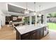 Modern kitchen boasts an island with quartz countertop and seamlessly connects to an open floor plan at 2805 Van Dyke Ave, Raleigh, NC 27607
