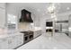 A modern kitchen featuring sleek white cabinetry, stainless steel appliances, and an oversized kitchen island at 2805 Van Dyke Ave, Raleigh, NC 27607