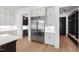 Bright kitchen with stainless steel appliances, white cabinets, and light hardwood floors at 2805 Van Dyke Ave, Raleigh, NC 27607