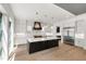 Gourmet kitchen featuring a large island with pendant lighting, stainless steel appliances and natural light at 2805 Van Dyke Ave, Raleigh, NC 27607