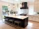 Spacious kitchen with large island, white cabinets, marble countertops, modern appliances and pendant lighting at 2805 Van Dyke Ave, Raleigh, NC 27607