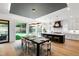 Open kitchen and dining area featuring modern lighting, stainless appliances and hardwood floors at 2805 Van Dyke Ave, Raleigh, NC 27607