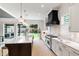 This kitchen has stainless steel appliances, white cabinets, and a kitchen island with dark cabinets at 2805 Van Dyke Ave, Raleigh, NC 27607