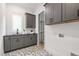 Stylish laundry room with gray cabinets, black countertop, geometric floor tiles, and closet at 2805 Van Dyke Ave, Raleigh, NC 27607
