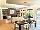 Open-concept living room and dining area with fireplace, hardwood floors, and sliding doors to outdoor living at 2805 Van Dyke Ave, Raleigh, NC 27607