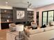 Comfortable living room with modern fireplace, built-in shelving, ceiling fan and stylish decor at 2805 Van Dyke Ave, Raleigh, NC 27607