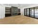Living room with modern fireplace, built-in shelves, and access to a patio at 2805 Van Dyke Ave, Raleigh, NC 27607