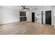 Spacious living room with wet bar, hardwood floors, black ceiling fan, and open layout at 2805 Van Dyke Ave, Raleigh, NC 27607