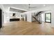 Spacious living room features kitchen, floating stairs, and natural lighting at 2805 Van Dyke Ave, Raleigh, NC 27607