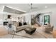 Open living space with hardwood floors, modern light fixture and staircase at 2805 Van Dyke Ave, Raleigh, NC 27607
