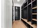 Mudroom area featuring black shelving units, seating, and hardwood flooring at 2805 Van Dyke Ave, Raleigh, NC 27607