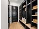 Hallway with storage and a bench, featuring dark cabinets and light hardwood floors at 2805 Van Dyke Ave, Raleigh, NC 27607