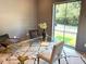 Office featuring a clear glass desk, stylish seating, and a large window with ample natural light at 2805 Van Dyke Ave, Raleigh, NC 27607