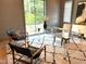 Stylish office with a clear glass desk, modern chairs, and a view of the outdoors at 2805 Van Dyke Ave, Raleigh, NC 27607