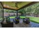 Cozy covered patio with an outdoor seating area, ceiling fan, and a view of the green backyard at 2805 Van Dyke Ave, Raleigh, NC 27607