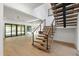 Open floor plan showcasing a modern staircase with wood treads, black stringers, and steel cable railings at 2805 Van Dyke Ave, Raleigh, NC 27607