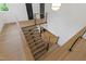 Open landing with modern staircase with wood treads, black stringers, and steel cable railings at 2805 Van Dyke Ave, Raleigh, NC 27607