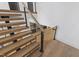 Close-up of modern staircase with wood treads, black stringers, and steel cable railings at 2805 Van Dyke Ave, Raleigh, NC 27607