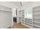 Well-lit walk-in closet with custom shelving and hanging rods, offering ample storage space, next to the sink at 2805 Van Dyke Ave, Raleigh, NC 27607