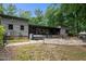 A view of backyard shows a hot tub, patio, outdoor fireplace, covered deck, and lush lawn at 3095 Champs Way, Mebane, NC 27302