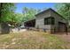 Back exterior of the home shows a covered patio, hot tub, and outdoor firepit at 3095 Champs Way, Mebane, NC 27302