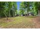 The well maintained backyard presents mature trees and modern home designs at 3095 Champs Way, Mebane, NC 27302