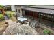 Aerial view of backyard shows hot tub, flagstone patio, covered deck, and lush landscaping at 3095 Champs Way, Mebane, NC 27302