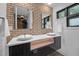 Modern bathroom featuring dual sinks, brick wall and stylish design at 3095 Champs Way, Mebane, NC 27302