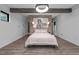 Spacious bedroom with exposed beams, brick detail and stylish lighting fixture at 3095 Champs Way, Mebane, NC 27302