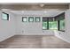 Spacious bedroom with wood floors, multiple windows, and wood beam ceiling at 3095 Champs Way, Mebane, NC 27302