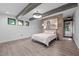 Modern bedroom featuring exposed beams, brick accent wall and stylish decor at 3095 Champs Way, Mebane, NC 27302