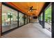 Spacious covered deck with wood ceiling, ceiling fans, and outdoor kitchen at 3095 Champs Way, Mebane, NC 27302
