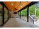 Covered deck equipped with a ceiling fan, outdoor kitchen, and a stone fireplace at 3095 Champs Way, Mebane, NC 27302